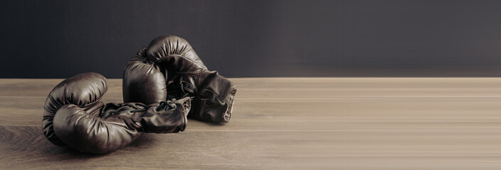 Boxing gloves on wooden table