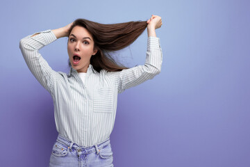 charming young brunette female adult with chic silky healthy hair below her shoulders in a studio background