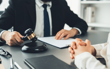 Lawyer colleagues or legal team working or drafting legal document at law firm office desk. Gavel...
