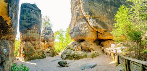Panoramic with sandstone rocks Schrammstein group at the hiking trail in the national park Saxon...