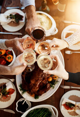 Wine, food and hands of people toast to celebrate at table for holiday, Christmas or thanksgiving...