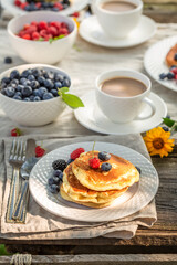 Homemade american pancakes with raspberries, honey and blueberries.