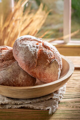 Tasty and homemade loaf of bread on rustic table.