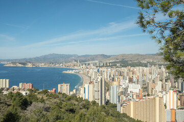 Panorama of famous Benidorm resort city from Serra Gelada Natural Park. Coast of Mediterranean sea, Benidorm skyscrapers, hotels and mountains in the background. Alicante province, Spain