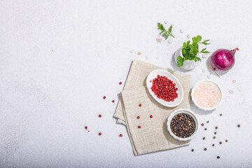 Kitchen cooking background with assorted peppercorn, purple onion, fresh parsley and sea salt