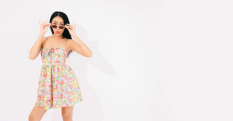 Joyful Asian lady in summer stand on pink background Debonair girl in dress excited Portrait young beautiful smiling asia female in trendy summer clothes Carefree happy woman wear sunglasses has fun