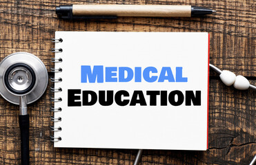 Medical Education words in a notebook next to a stethoscope.