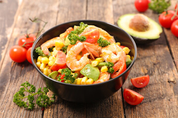 bowl of mixed salad with shrimp, avocado, tomato and corn