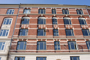 Facade of a apartment building iwith windows the center of Copenhagen in Denmark