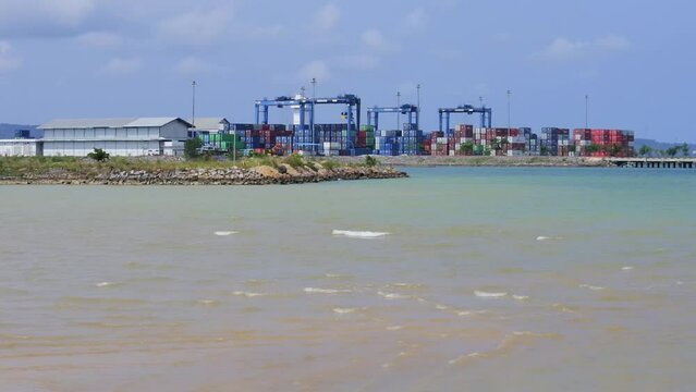 Container port with Nambo beach in the foreground, Kendari, Indonesia
