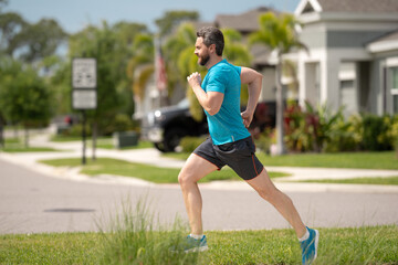 Sport runner. Man running. Fit male sport fitness model sprinting outdoors. Attractive man running fast, workout outdoors, runner jogging over american street.