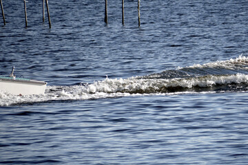 stern wave of a small boat on a lake
