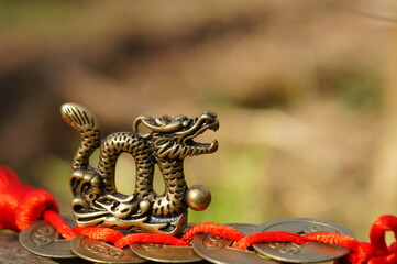 Dragon figurine and Chinese coins. A religious symbol.