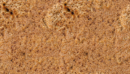 Close up of a whole rye bread as a background texture composition.
