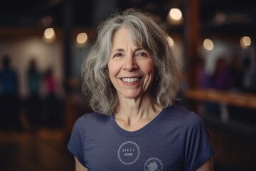 Portrait of happy senior woman smiling at camera in cafe. Mature woman with gray hair.