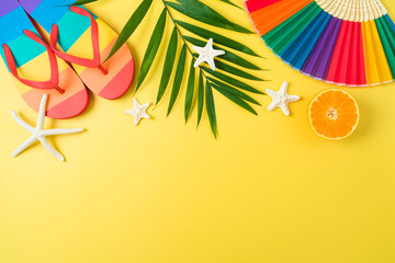 LGBTQ pride month beach party background with rainbow flip flops and  paper fan. Top view, flat lay