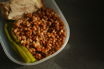 container with healthy food, buckwheat, chicken breast and asparagus