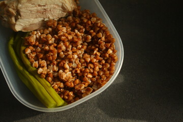 container with healthy food, buckwheat, chicken breast and asparagus