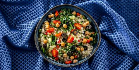 A plate of couscous served with vegetables and chickpeas