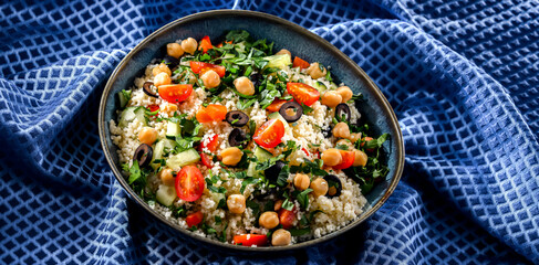 A plate of couscous served with vegetables and chickpeas