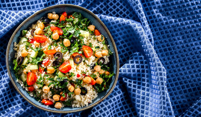 A plate of couscous served with vegetables and chickpeas