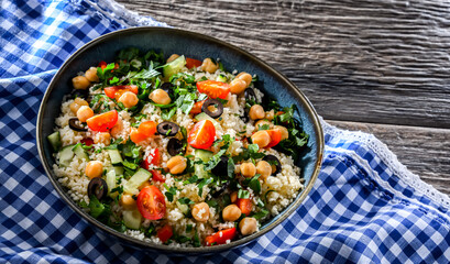 A plate of couscous served with vegetables and chickpeas
