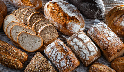 Assorted bakery products including loaves of bread and rolls