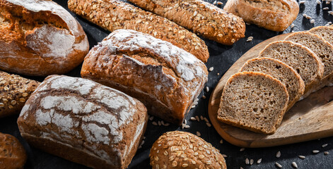 Assorted bakery products including loaves of bread and rolls