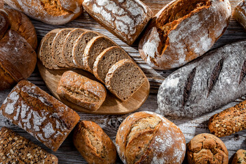 Assorted bakery products including loaves of bread and rolls