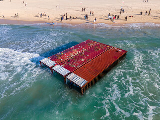 Containers that fell from the ship lie on the seashore