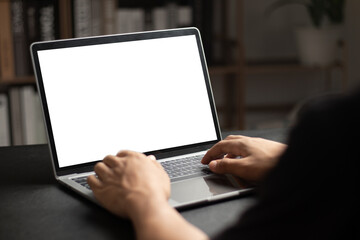 Mockup of man using and typing on laptop with blank white desktop screen. - obrazy, fototapety, plakaty