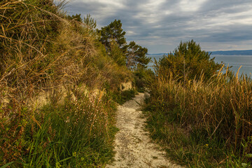 A hiking path along the coastside beach of the adriatic sea near Stobrec, Dalamatia, Croatia, in early spring