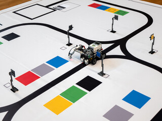 Line Following Robot is doing task to move from one point to another on the mat. Programmable robots
