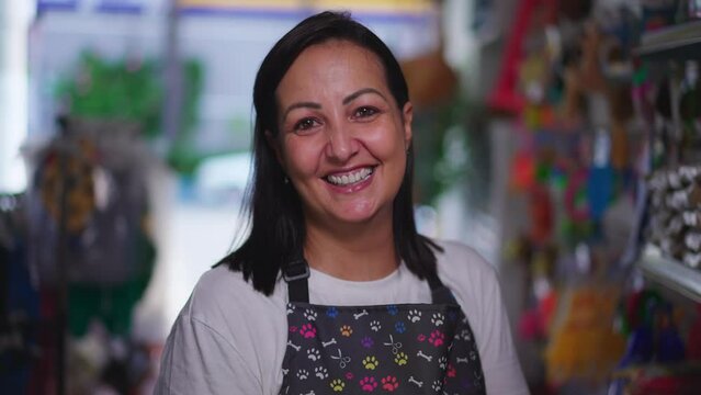 Happy female local Pet Shop owner smiling at camera portrait face close-up smiling inside Store wearing apron