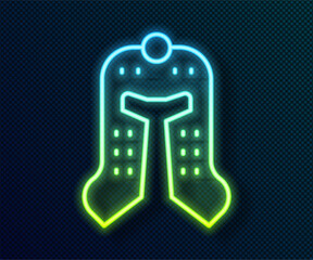 Glowing neon line Medieval iron helmet for head protection icon isolated on black background. Vector