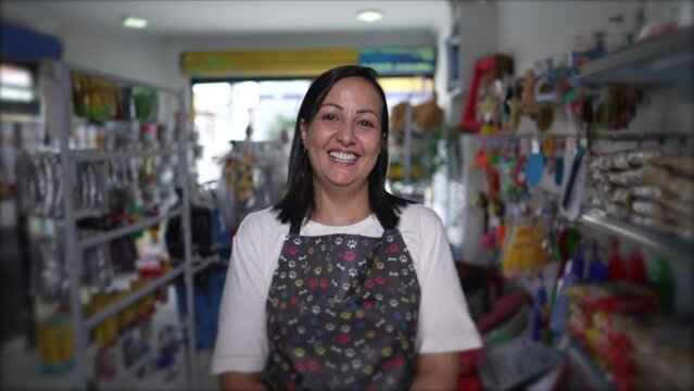 Happy Local Pet Shop Female Owner Portrait face close-up standing inside inside Store smiling. Woman wearing apron looking at camera