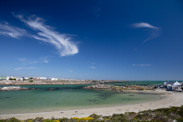 A view of Jacobs Bay, South Africa with green ocean and blue sky