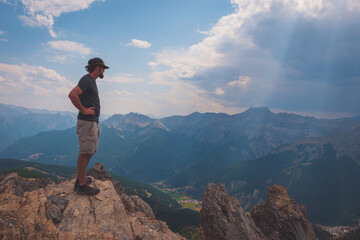 Fototapeta na wymiar A male hiker standing on top of Sommet de Tronchet (Hautes-Alpes, France)