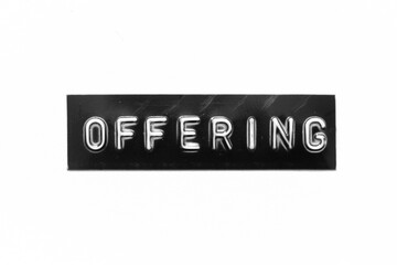 Black color banner that have embossed letter with word offering on white paper background