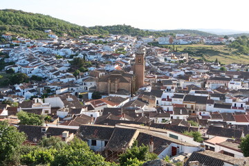 Cortegana, Huelva, Spain, May 12, 2023: White houses of the Andalusian magical town of Cortegana, Huelva, Spain with the Divino Salvador church in the center