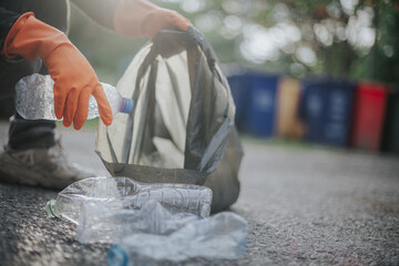 Man holding trash bags collecting trash and separating waste to refresh the problem of environmental pollution and global warming. Plastic waste. Caring for nature. volunteer concept