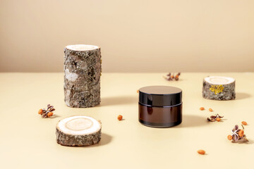 jar for cream and sections of a tree with lichens on a beige background