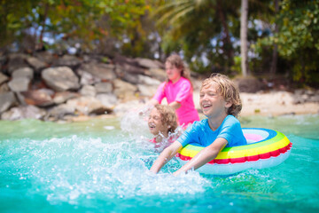 Kids playing on tropical beach. Summer fun.