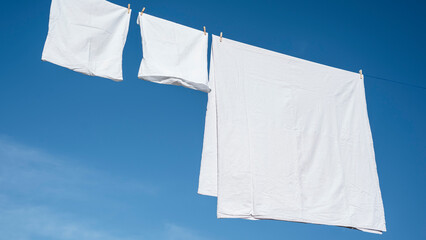 Clothes hanging to dry on a laundry line - 602091639