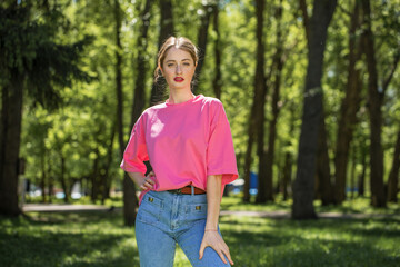 Portrait of a young beautiful brunette  girl in summer park