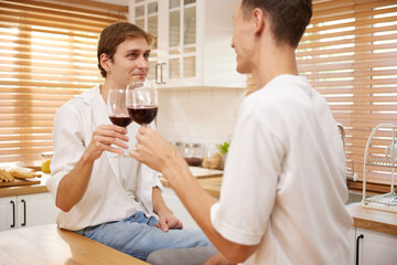 LGBT gay couple talking with boyfriend and drinking wine in dining room