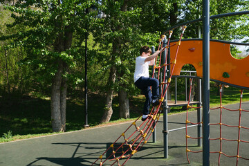 Cute little boy is playing on the playground.