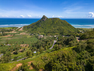 Lush rural landscape with Selong belanak beach in distance, Lombok, Indonesia