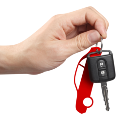 Hand holding a car key, cut out