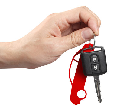 Hand holding a car key, cut out